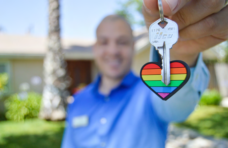 Man holding rainbow heart keychain